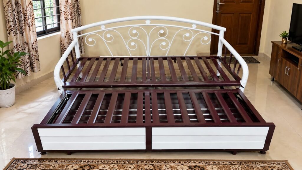 Maroon and white metal sofa cum bed by Tuba Furniture, Pune